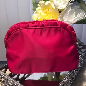 Hot pink satin ruffle trim cosmetic bag.